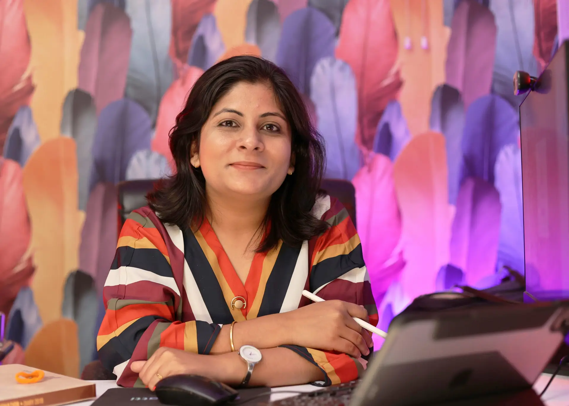 Confident woman sitting at a desk with digital tools, ready to teach or take online business courses—representing modern design entrepreneurship and remote learning.