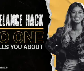 Smiling woman designer while holding a note pad, representing strategies to scale a freelance design business.