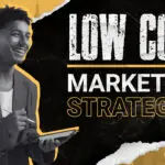 Smiling design entrepreneur holding a digital tablet and stylus, with bold text that reads “Low Cost Marketing Strategies.”