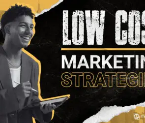 Smiling design entrepreneur holding a digital tablet and stylus, with bold text that reads “Low Cost Marketing Strategies.”