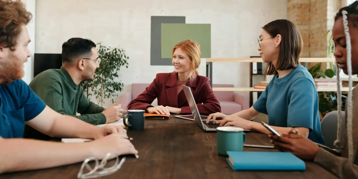 Group of diverse freelance design entrepreneurs having a meeting in a modern office
