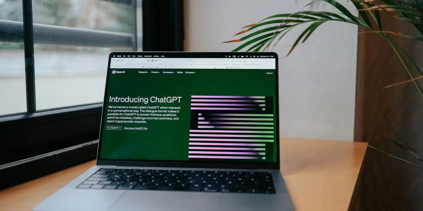 ChatGPT homepage on laptop screen showing its features and conversational interface