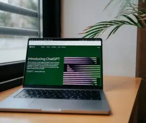 ChatGPT homepage on laptop screen showing its features and conversational interface