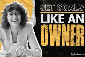 Smiling creative professional sitting at a desk with the motivational phrase “Set Goals Like an Owner,” representing a mindset shift for design entrepreneurs to build and scale successful design businesses.