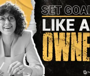 Smiling creative professional sitting at a desk with the motivational phrase “Set Goals Like an Owner,” representing a mindset shift for design entrepreneurs to build and scale successful design businesses.