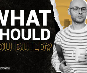 Designer holding tablet and coffee next to text asking what business to build.