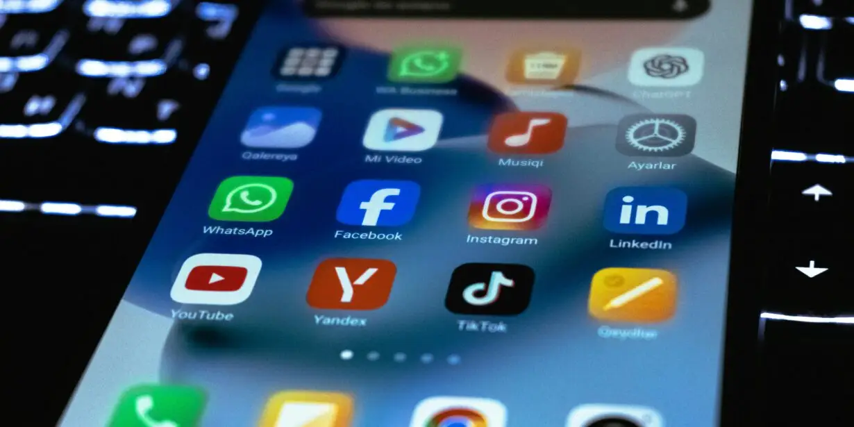 Smartphone displaying social media marketing apps.