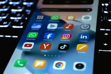 Smartphone displaying social media marketing apps.