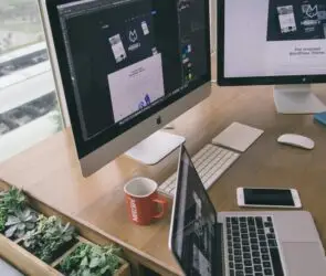 Professional design workspace with multiple screens showing website and digital product development.