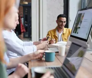 Creative team collaborating in a meeting to discuss digital design projects and licensing opportunities.
