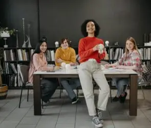 Group of creative professionals collaborating around a table in a modern workspace.