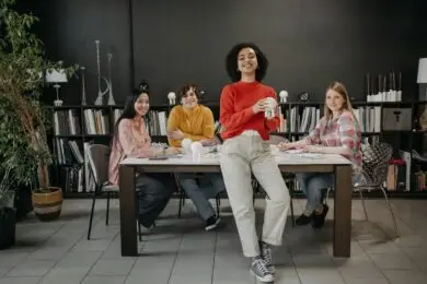 Group of creative professionals collaborating around a table in a modern workspace.